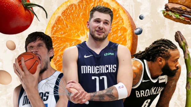 Boban Marjoanovic, Luka Doncic and DeAndre Jordan surrounded by food